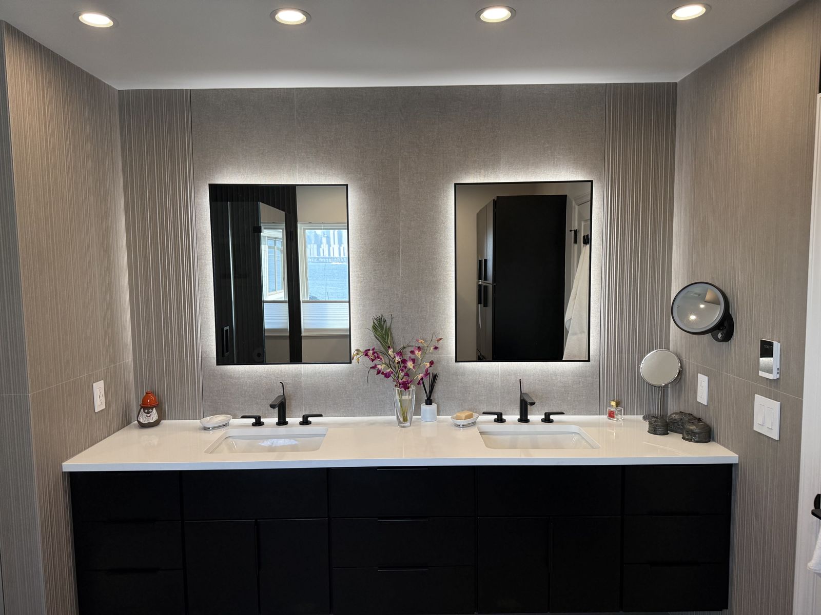 Double vanity with backlit mirrors