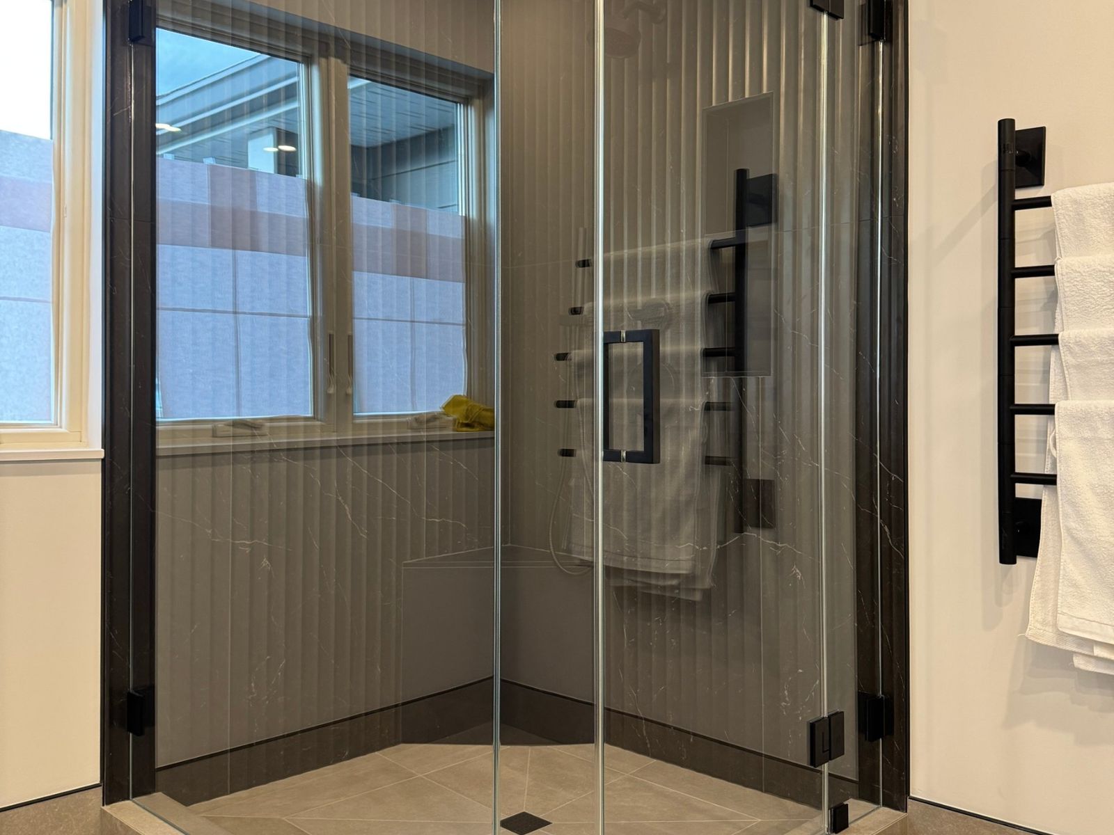 Corner glass shower, black hardware